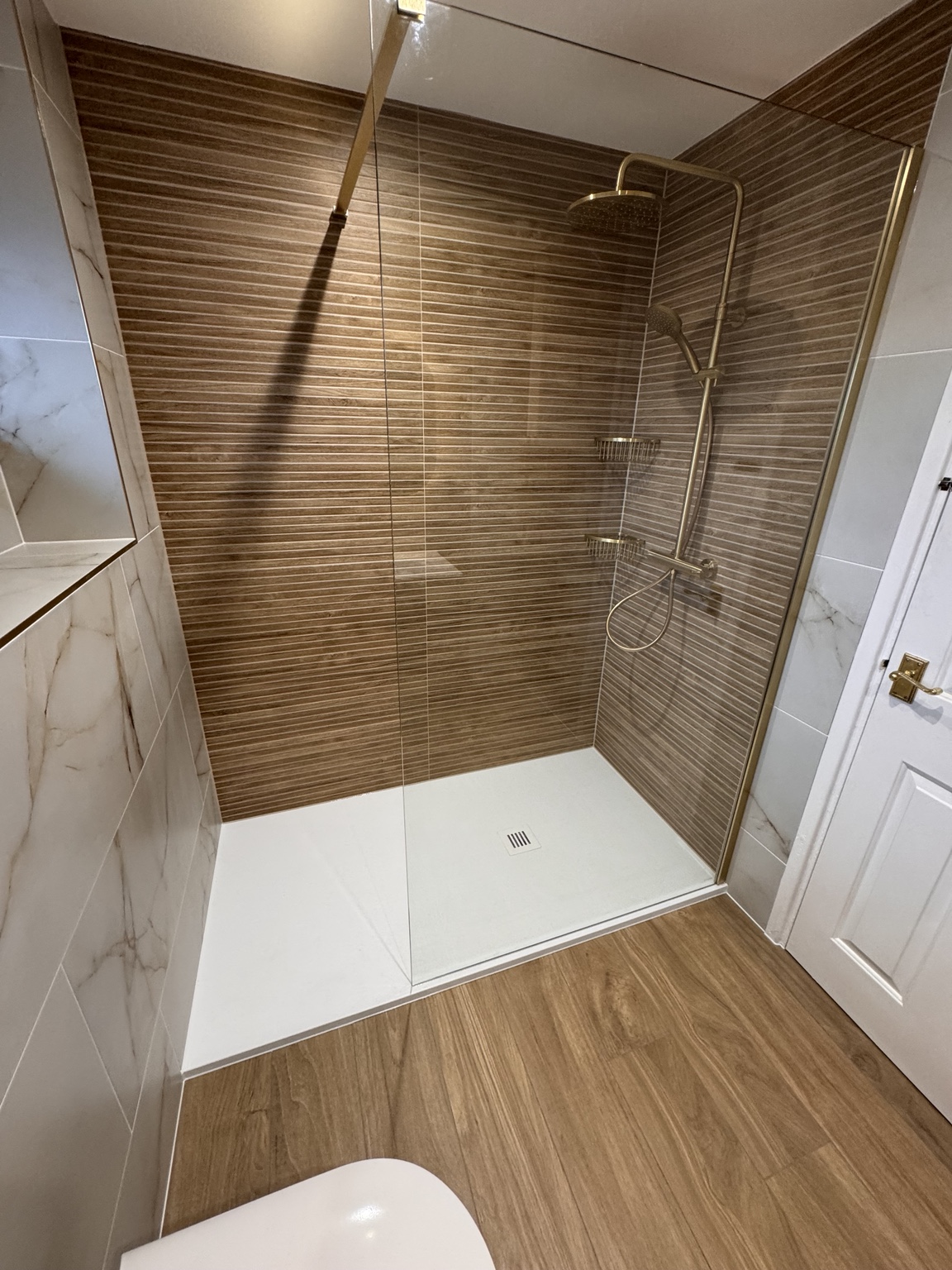 White slate shower tray and brass Vado shower