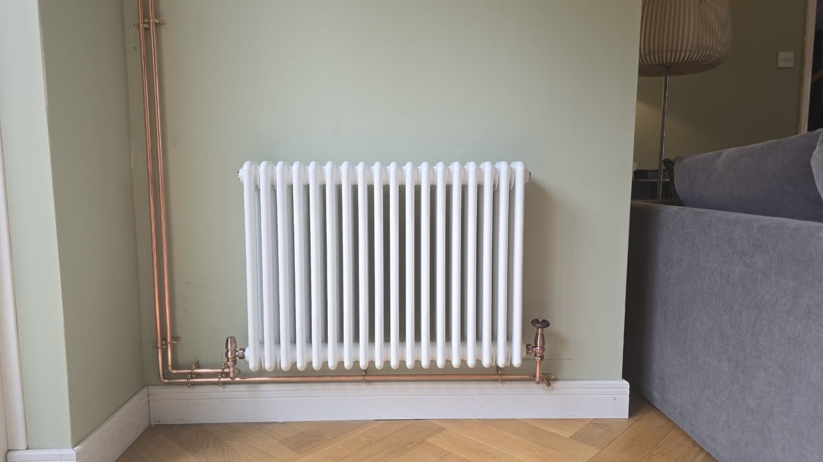 Traditional column radiator with copper pipework installed by SMC