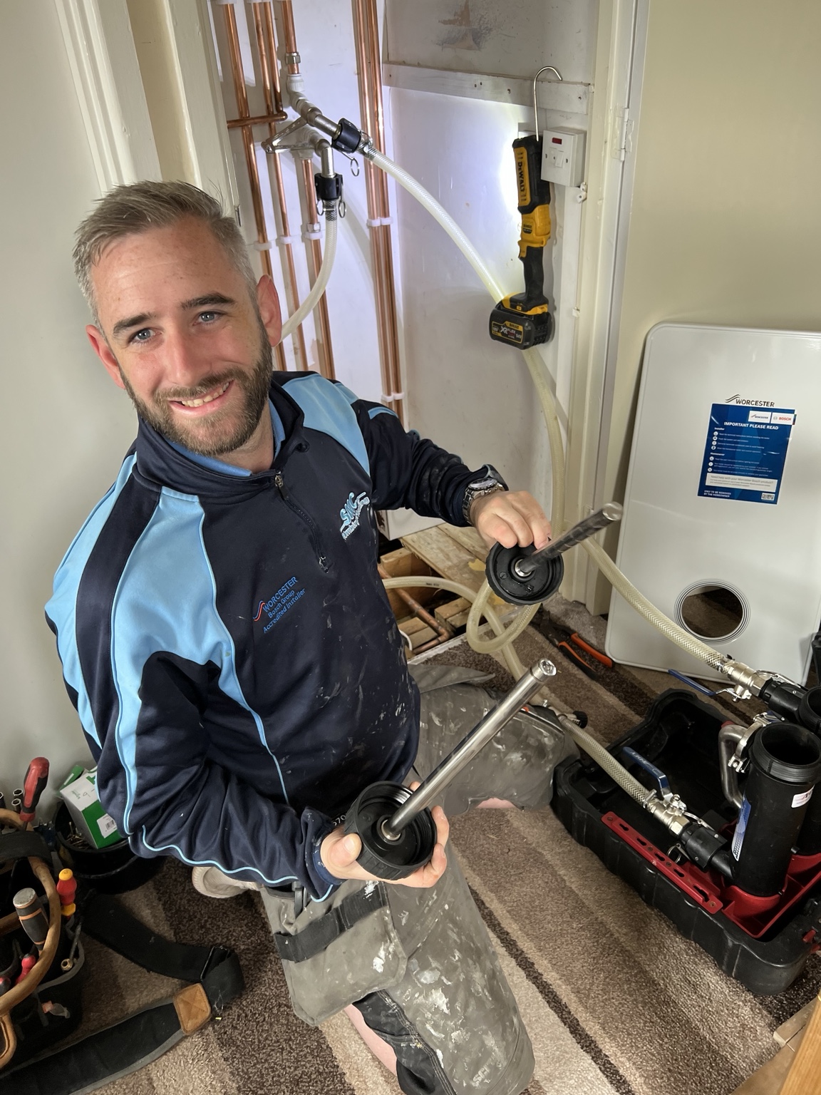 Rob, SMC Plumbing and Heating engineer, working on a boiler system